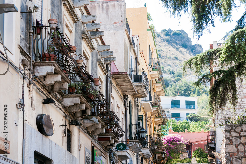 Travel to Italy -  historical street of Taormina, Sicily, facade of old buildings