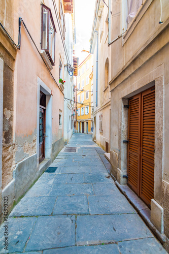 Old and narrow streets in Piran city  Slovenia. Ancient medieval streets in town center of famous European city  near the adriatic sea. Old houses with wooden windows and doors  magical atmosphere.