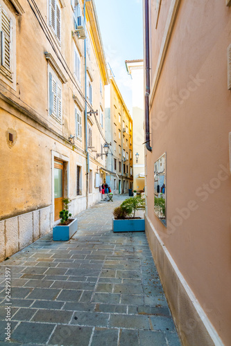 Old and narrow streets in Piran city  Slovenia. Ancient medieval streets in town center of famous European city  near the adriatic sea. Old houses with wooden windows and doors  magical atmosphere.