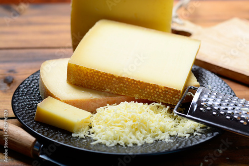 Assortment of Swiss cheeses Emmental or Emmentaler medium-hard cheese with round holes, Gruyere, appenzeller and raclette used for traditional cheese fondue and gratin