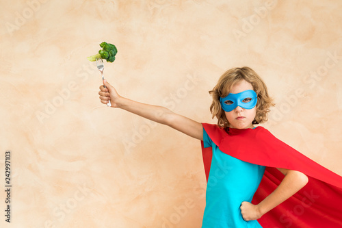 Superhero child eating superfood photo