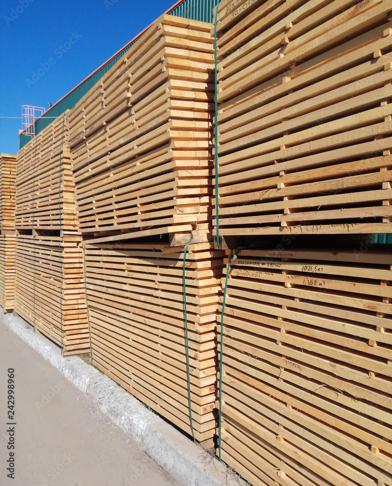 stack of wooden planks at the lumber yard stack of wooden planks at the lumber yard