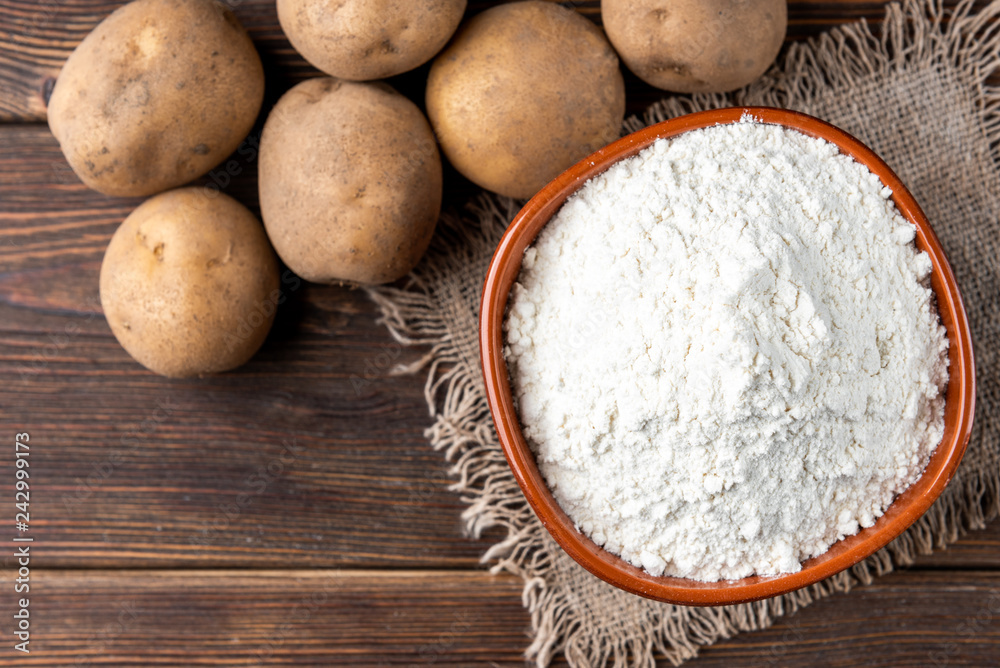 Potato starch on dark wooden background. Potato starch on dark wooden background.