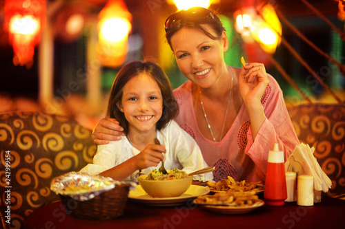 Portrait of happy mother and daughter eating