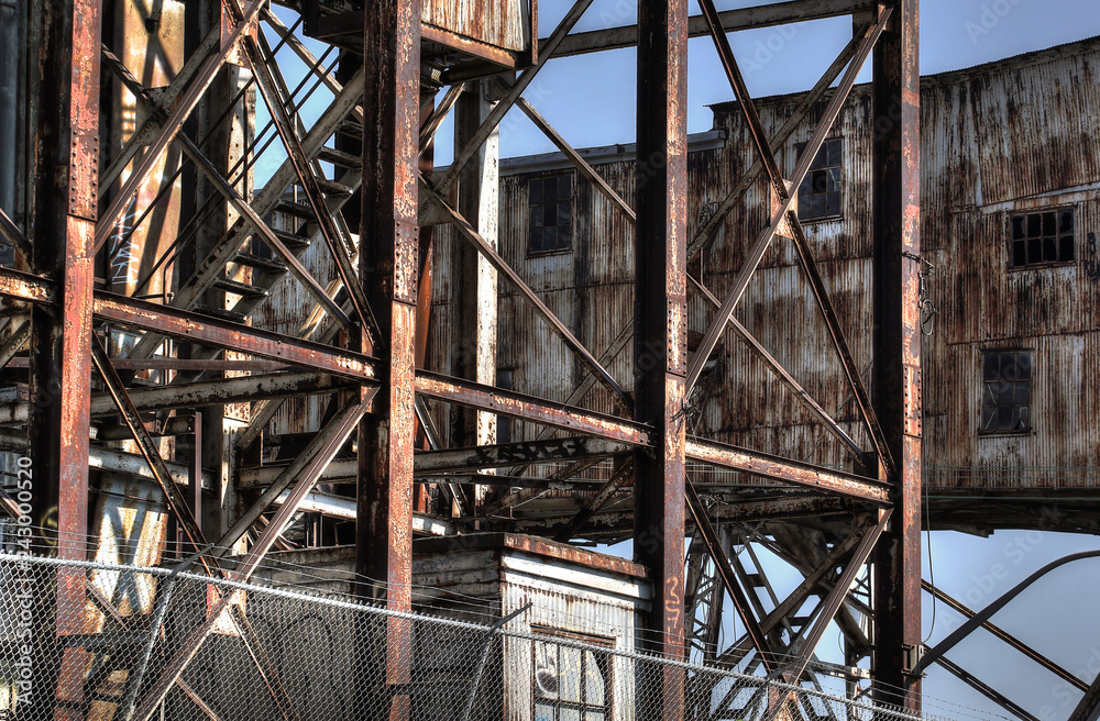 Fototapeta premium Abandoned rusted industrial structures in old port