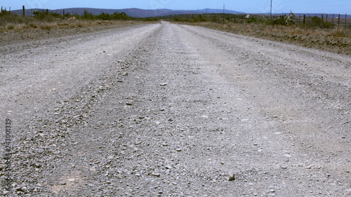 Low angle shot of a wide grave or dirt road in the countryside.