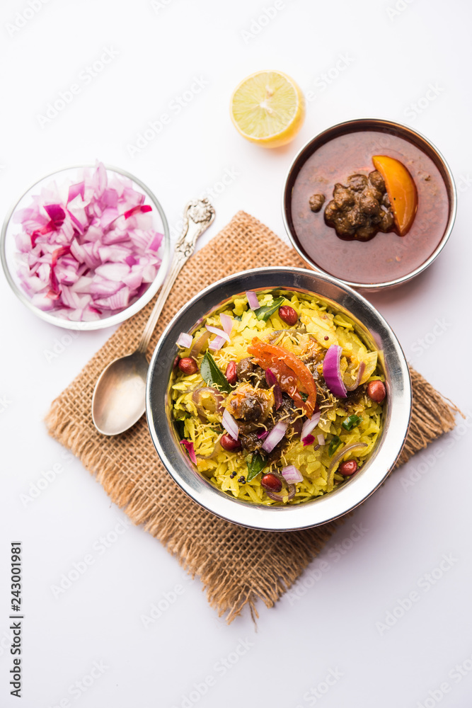 Aloo/Kanda Poha or Tarri Pohe with spicy chana masala/curry. selective focus Aloo/Kanda Poha or Tarri Pohe with spicy chana masala/curry. selective focus