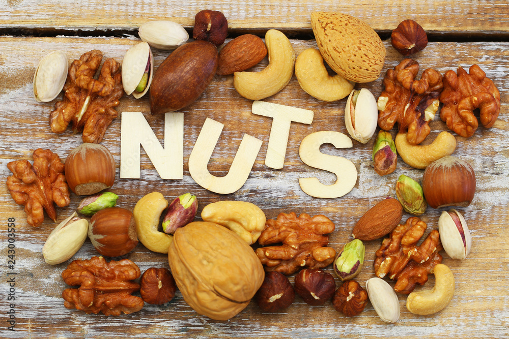 Word nuts written with wooden letters on rustic wooden surface with