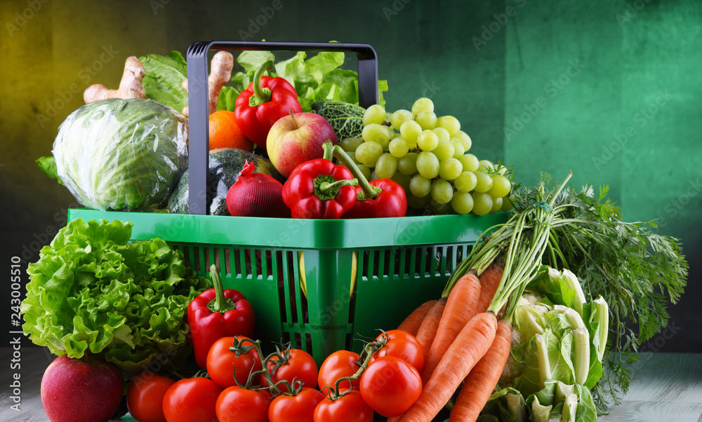 Fresh organic fruits and vegetables in plastic shopping basket - obrazy, fototapety, plakaty 