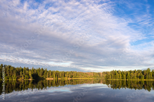 clouds over a forest lake