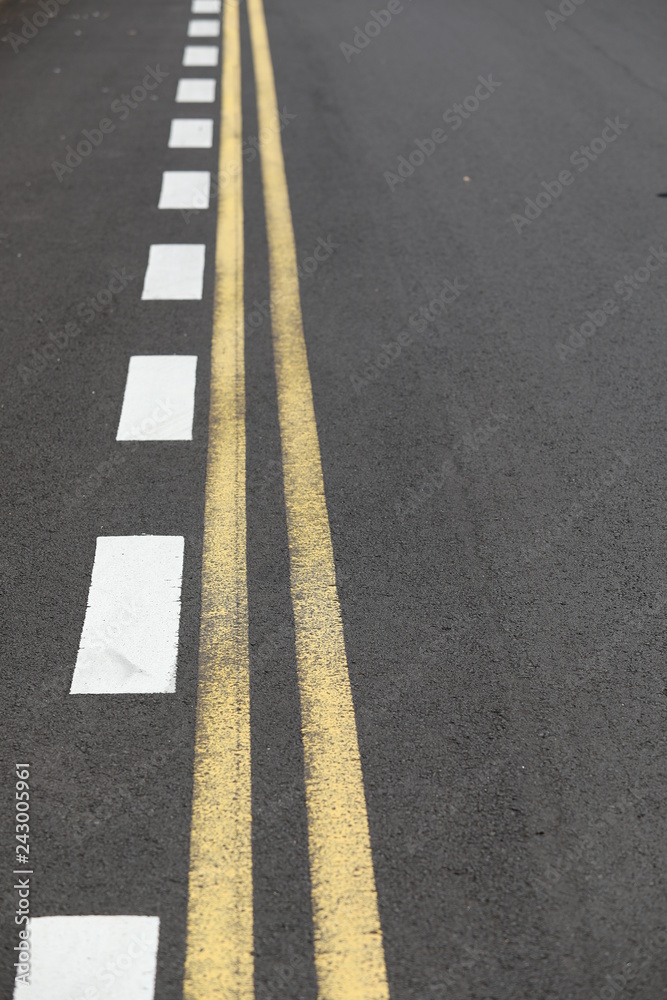 Close up straight and smooth asphalt road with one continuous marking Close up straight and smooth asphalt road with one continuous marking