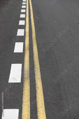Close up straight and smooth asphalt road with one continuous marking