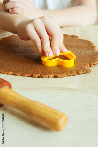 Young child hands is preparing the dough, bake cookies in the kitchen. Close up concept of family leasure