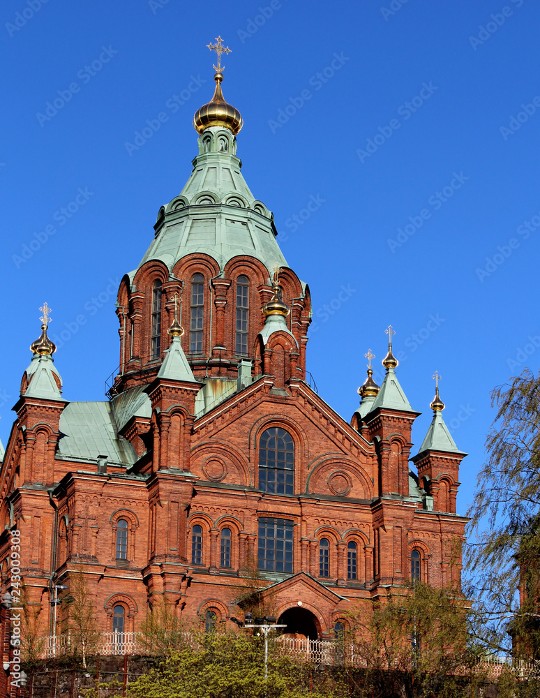 Orthodox Uspenski Cathedral with red bricks and blue sky in spring in Helsinki