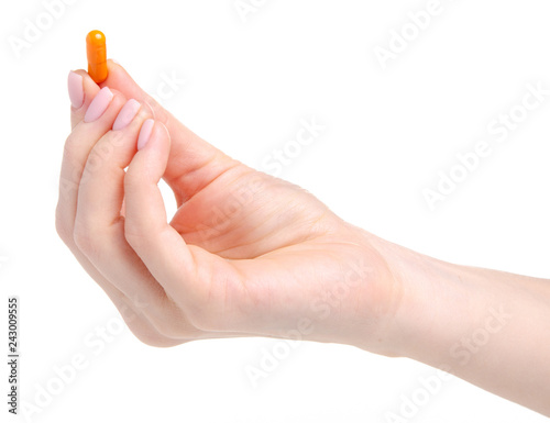 Pill capsule orange in hand medicine health on white background isolation