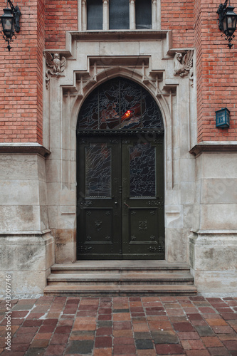 Vertical picture of old architecture door with brick wall outdoor