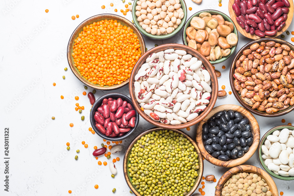 Legumes, lentils, chikpea and beans assortment on white.