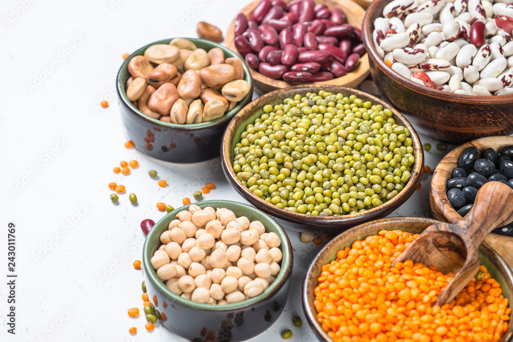 Legumes, lentils, chikpea and beans assortment on white.