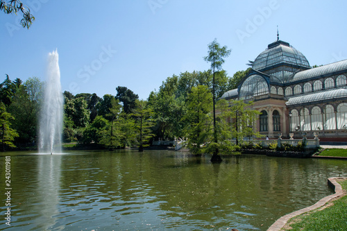 Famous Crystal Palace or Palacio De Cristal in Buen Retiro Park near pond. Madrid, Spain
