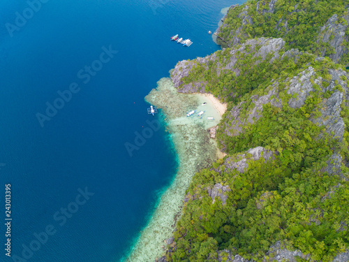 Aerial view to tropical lagoon with azure water and traditional sailing boat near Barracuda Lake, Coron island. Palawan, Philippines.