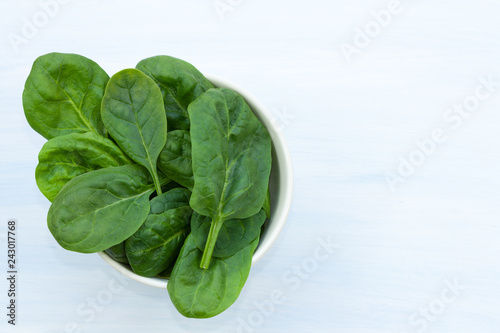 Fresh spinach leaves in a bowl.