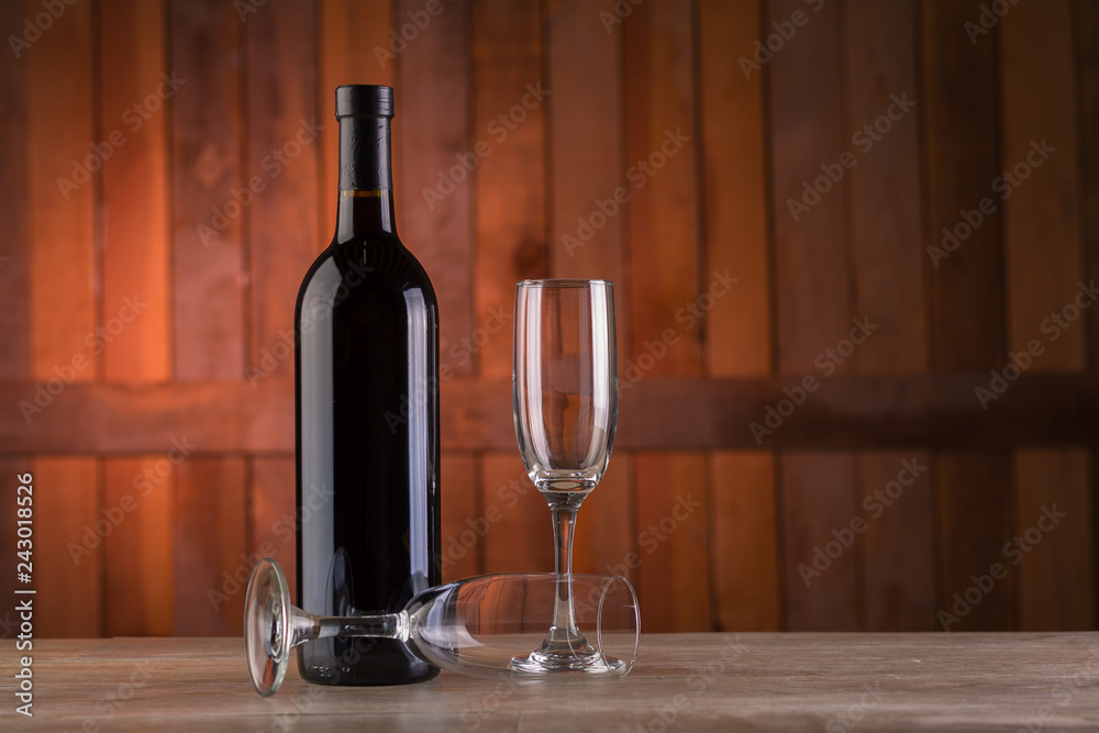 bottle of wine and two glasses on wooden table