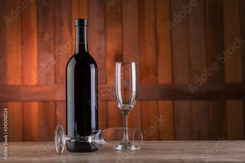 bottle of wine and two glasses on wooden table © Teran
