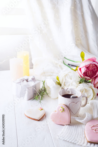 romantic breakfast in bed. Coffee   cookies  gift box and flower on wooden table. Valentine s day concept