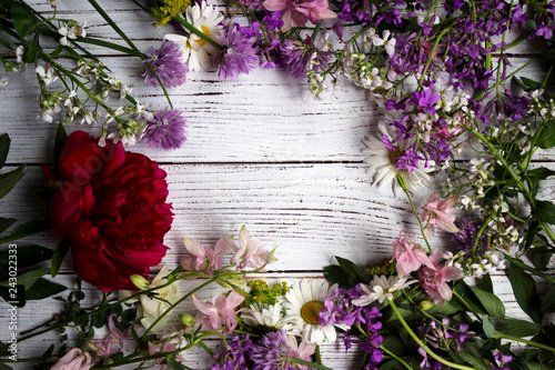 Fototapeta Naklejka Na Ścianę i Meble -  Red, white and lilac flowers on white wooden background, Flatley