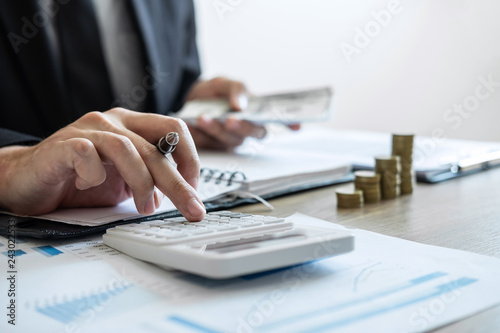 Businessman accountant counting money and making notes report doing finance