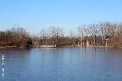 The calm water of the lake in the country on a sunny day.