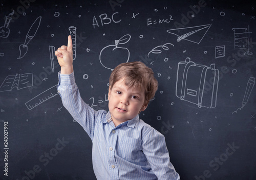 Smart little kid in front of a drawn up blackboard ruminate