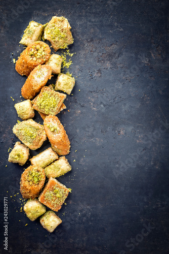 Traditional Oriental baklava collection as top view on a black board with copy space right photo