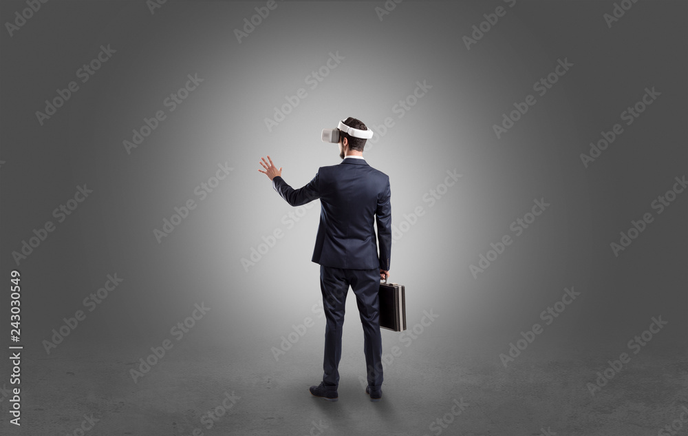 Businessman wearing vj glasse in an empty room with no wallpaper
