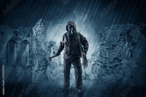 Hazard, menace man in a ruined crumbly building with arms on his hand
