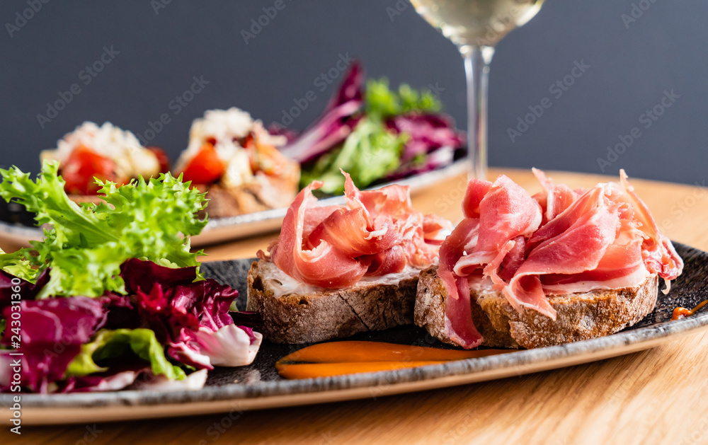 Sandwich with prosciutto, cheese and lettuce