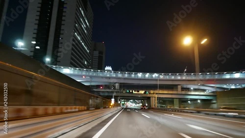Hyperlapse on the highway in Tokyo at night. Drive nonstop to the city center via tunnel, bridge of tourist attraction, skyscrapers, famous tower. photo