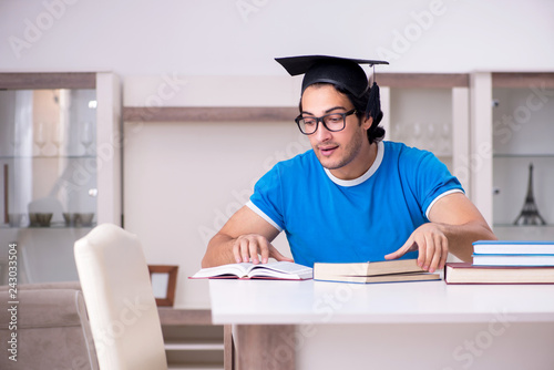 Young handsome student studying at home 