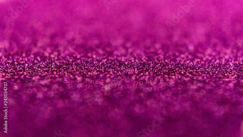 Glitter background in pink / purple / magenta color. Festive background. Small size particles. Magic glowing effect. Perfect for phone wallpaper, festive invitation or greeting card.