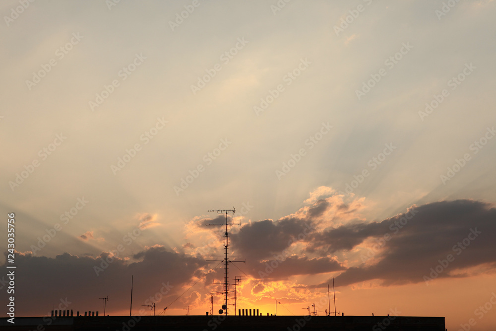 Television antennas on the roof pictured at sunset