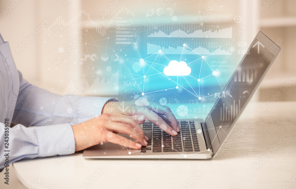 Business woman in homey environment using laptop with cloud technology concept
