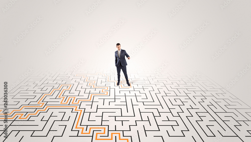 Young entrepreneur standing in a middle of a labyrinth with the solution
Young entrepreneur standing in a middle of a labyrinth with the solution