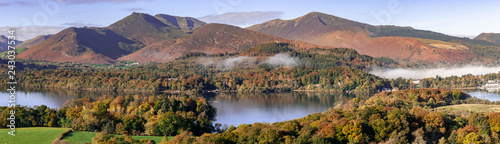 A panorama of cloud over Derwent Water lake in the Lake District Cumbria with Autumn colours and mountains in the background © Jeremy