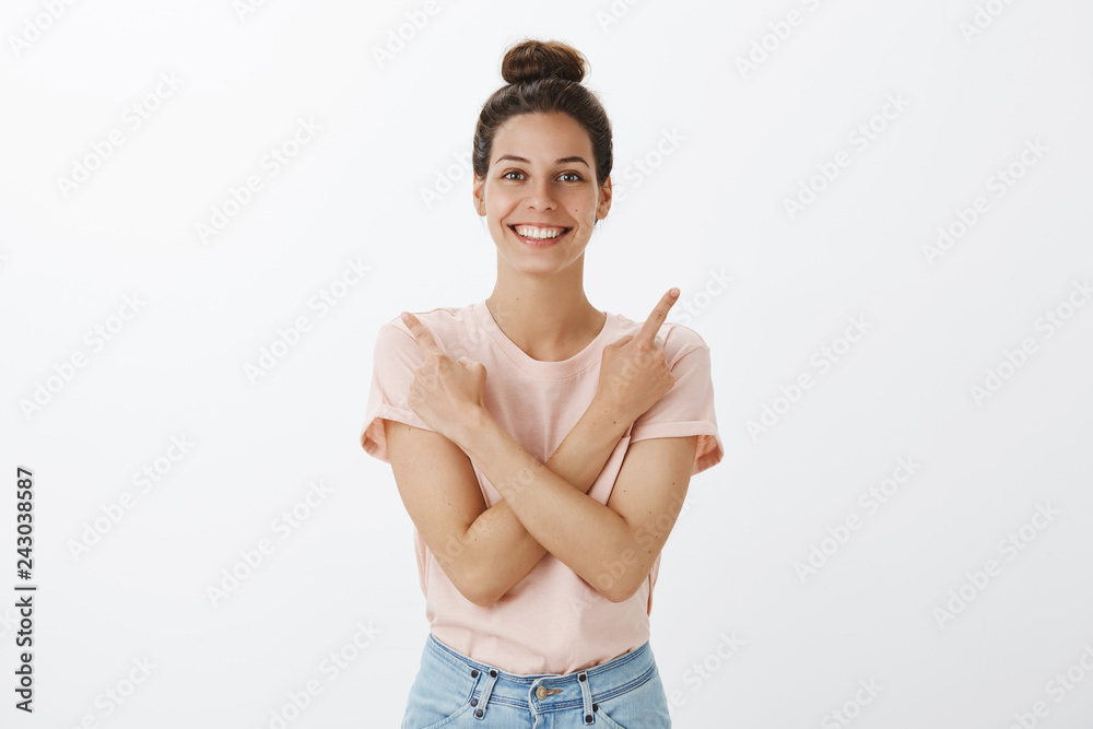 Both choices great, pick one. Positive and optimistic attractive stylish caucasian female with hairbun in t-shirt crossing hands on chest point sideways, showing left and right corner with nice smile Both choices great, pick one. Positive and optimistic attractive stylish caucasian female with hairbun in t-shirt crossing hands on chest point sideways, showing left and right corner with nice smile