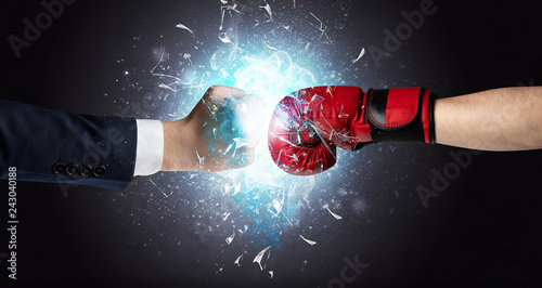 Two hands fighting and breaking glass into small pieces with blue light concept   © ra2 studio