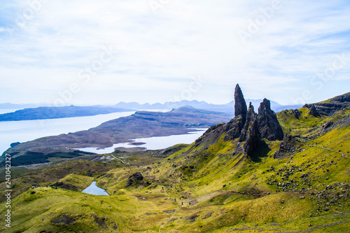 Travel Europe, Scotland, Highlands, Isle of Skye (Tourist popular destination). Scenic mountain landscape view of The Old Man Of Storr attraction, sharp rocks and lakes on background in summer time.