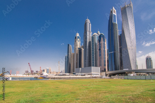 Luxury Dubai Marina skyscrapers and nature around green park, United Arab Emirates photo