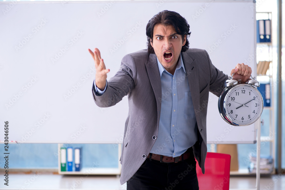 Young handsome teacher in front of whiteboard Young handsome teacher in front of whiteboard