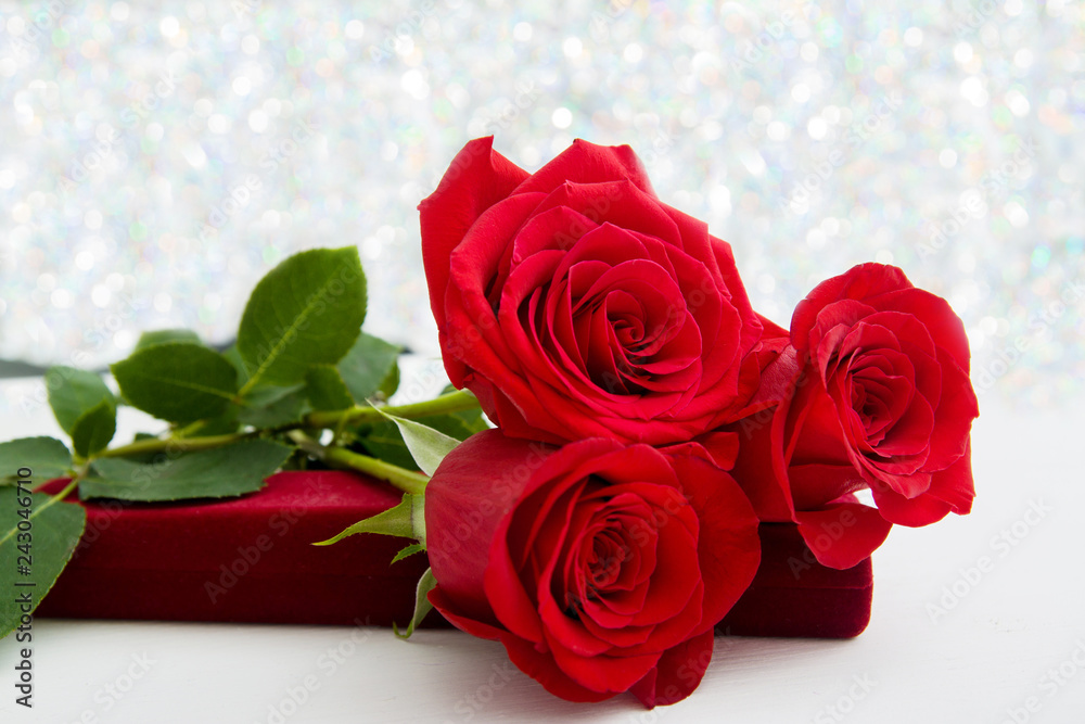 Three Red Roses and jewelery present box with boke Background. copy space - Valentines and 8 March Mother Women's Day concept.