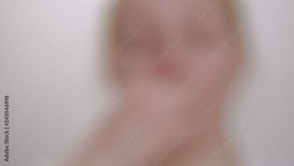 Woman shows a tablet while holding it with her fingers, then swallows it and drinks it with water Woman shows a tablet while holding it with her fingers, then swallows it and drinks it with water